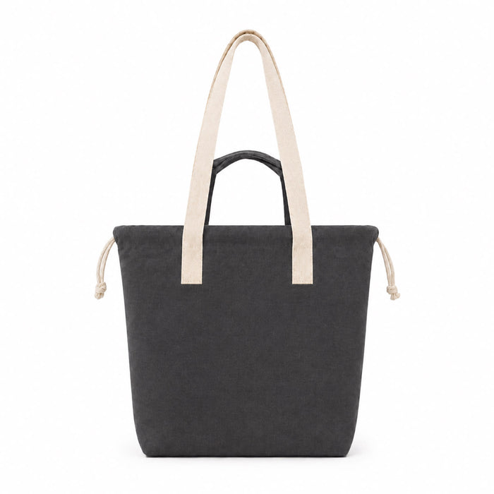 Darby Tote Bag - A dark grey tote bag with light beige straps and drawstring closures, featuring a simple design and a logo.