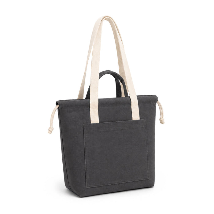 Darby Tote Bag - A dark grey tote bag with contrasting cream handles and a front pocket, featuring a branded logo.