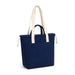 Darby Tote Bag - A navy tote bag with cream handles and a front pocket, featuring a logo on the side.