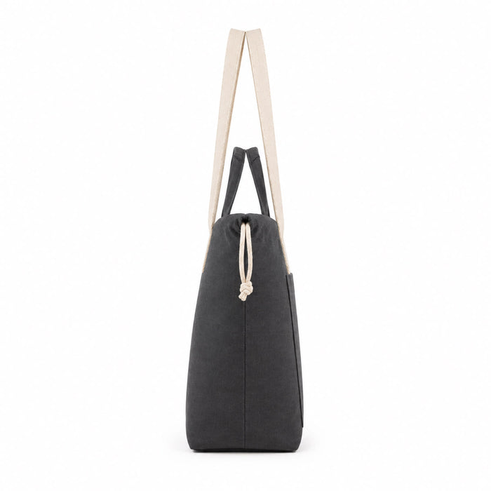 Darby Tote Bag - A grey tote bag with cream straps and a drawstring closure, featuring a side pocket.
