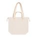 Darby Tote Bag - A cream tote bag with double handles and a front pocket, featuring a simple design and a logo on the side.
