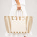 Hampton Tote Bag by The Line Edit. - A striped tote bag in beige and cream, featuring a large front pocket and sturdy handles.