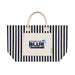Hampton Tote Bag by The Line Edit. - A striped tote bag with a cream base and navy blue stripes. It features a front pocket and a logo.
