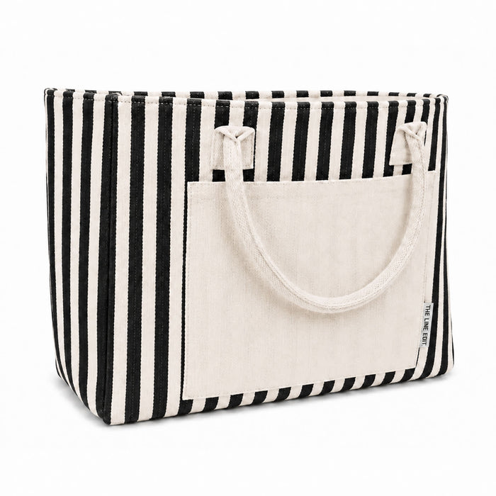 Hampton Tote Bag by The Line Edit. - A striped tote bag with black and cream colours, featuring a front pocket and two top handles.