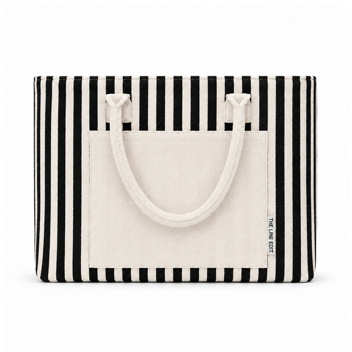 Hampton Tote Bag by The Line Edit. - A striped tote bag in black and cream with sturdy handles and a front pocket, featuring a logo.