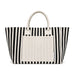 Hampton Tote Bag by The Line Edit. - A striped tote bag in black and white with a plain cream-coloured front pocket and handles. It has a logo.