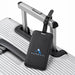 Jet Luggage Tag Tracker - A black luggage tag tracker attached to the handle of a silver suitcase, featuring a logo.