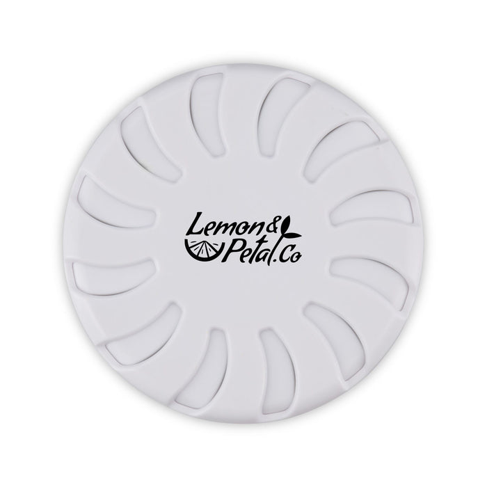 Bloom Fragrance Pot - A round white fragrance pot with a floral design and a logo in the centre.