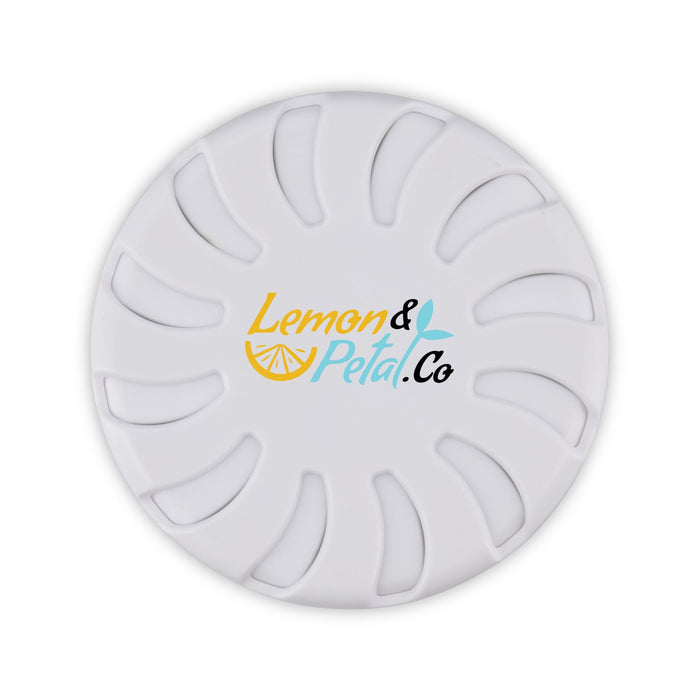 Bloom Fragrance Pot - A round, white fragrance pot with a decorative logo in yellow and teal. Features a floral design on the surface.