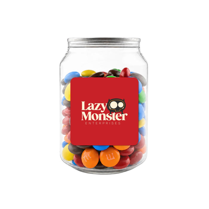 M&M's in Clear Can 180g - A clear jar filled with colourful M&M's in various shades, featuring a distinct logo on the front.