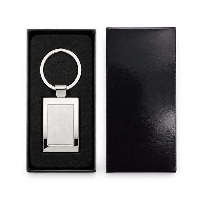 Frame Keytag - A stainless steel keytag with a rectangular frame, presented in a sleek black box with a soft interior.