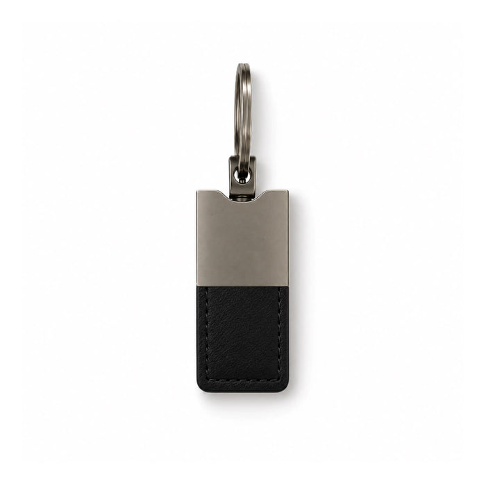 Mario Keytag - A sleek keytag featuring a black leather base and a silver metallic top, attached to a metal ring.