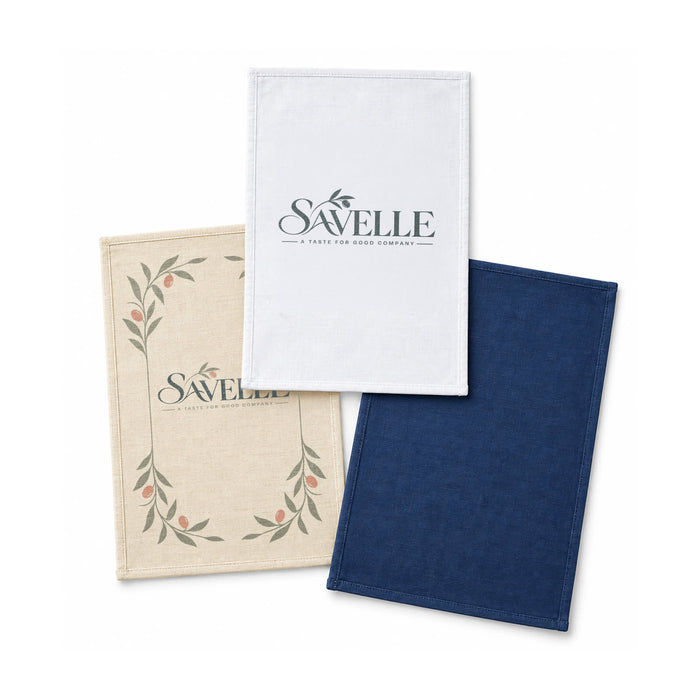 Haven Medium Cotton Tea Towel - Three medium cotton tea towels in cream, white, and navy blue, featuring a logo on one towel.