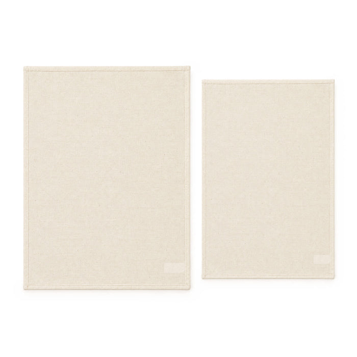 Haven Large Cotton Tea Towel - Two cotton tea towels in a light beige colour, one larger and one smaller, both featuring a brand logo.