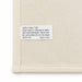 Haven Large Cotton Tea Towel - A cream cotton tea towel featuring a care label with washing instructions and a brand logo.