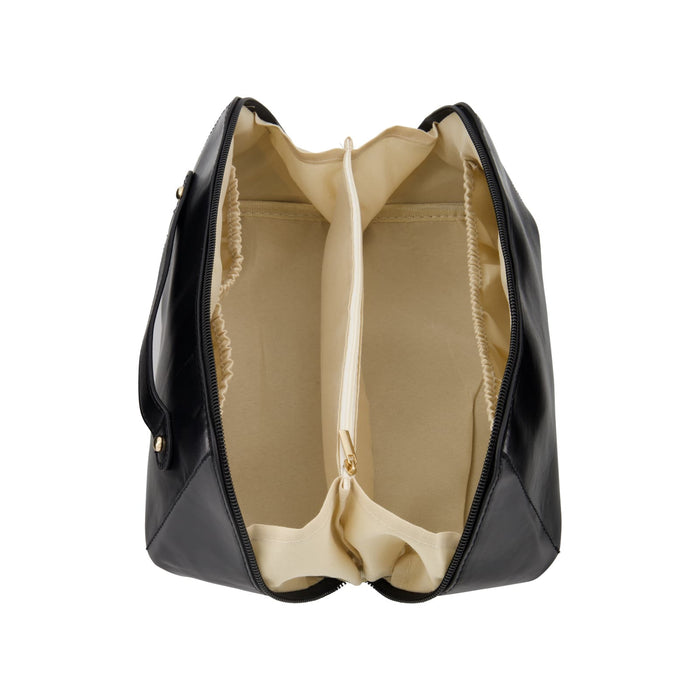 The Polished Traveller - A black toiletry bag with a cream interior, featuring two main compartments separated by a zippered section and a logo.