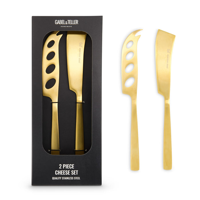 The Glow & Graze: Christmas Edition - A cheese set featuring two stainless steel knives with a gold finish, presented in a black box.