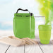 Picnic Pack - A green picnic bag contains a drink bottle, reusable cup, utensils, and food containers, set against a blurred outdoor background.