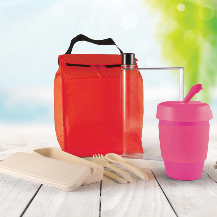 Picnic Pack - A red picnic bag contains a clear drink bottle, a pink cup with a straw, and bamboo utensils, along with a food container.
