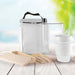 Picnic Pack - A white picnic pack with a drink bottle, a reusable cup, and eco-friendly utensils, set against a blurred outdoor background.