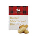 The Brew Ritual - A box of Scottie Dog butter shortbread biscuits with a red tartan design. Three biscuits are displayed in front of the box.