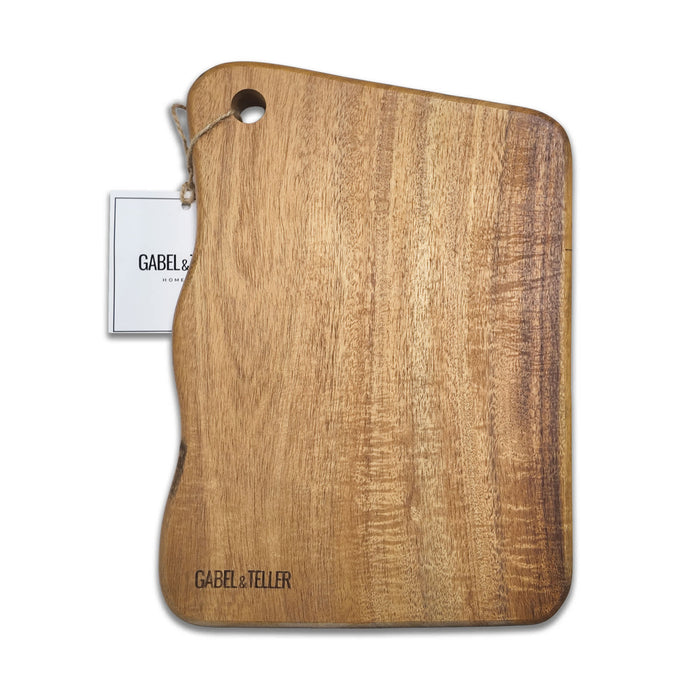 The Chandon Escape - A wooden cutting board with a natural finish, featuring an irregular shape and a hole for hanging. It has a branding logo.