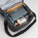 The Refined Graze - A cooler bag in grey containing a cheese set, jar, and assorted snacks. The interior is lined with silver material.