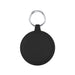 The Ultimate Welcome - Hot Chocolate Edition - A round black keychain holder features a silver keyring. The surface is smooth with subtle grooves around the edge.