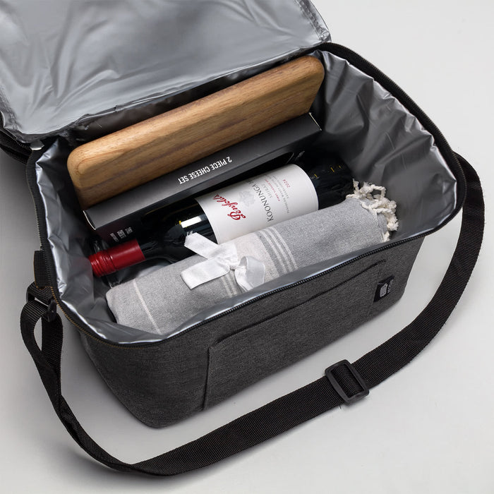 The Sunset Pour - A drink bottle cooler bag in grey containing a bottle of wine, a rolling pin, and a rolled-up blanket.