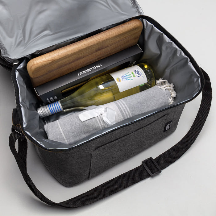 The Sunset Pour - A drink bottle and a blanket inside a grey cooler bag, with a wooden board on top and a black box.
