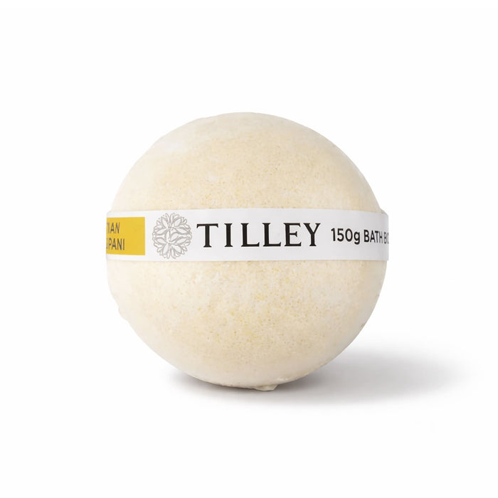 The Cosy Indulgence - A bath bomb in a round shape, cream-coloured with a yellow label featuring branding.