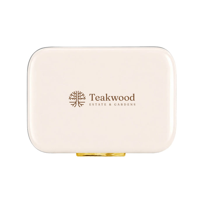 Pavilion Cooler by The Line Edit. - A cream-coloured cooler with a gold clasp and a logo. The design features a rectangular shape.