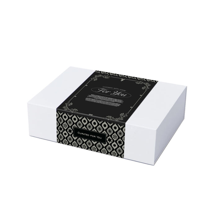 The Perfect Pairing: Christmas Edition - A gift box featuring a black and white patterned design, wrapped with a decorative band.