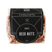 The Good Things - A clear plastic bag containing roasted beer nuts, showcasing a mix of light brown and tan nuts. The bag features a black label with branding.