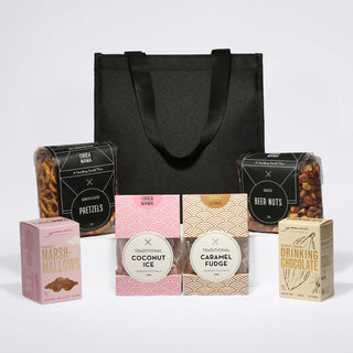 The Treat Kit - A black cooler bag filled with pretzels, beer nuts, and assorted sweet treats including coconut ice, caramel fudge, and marshmallows.
