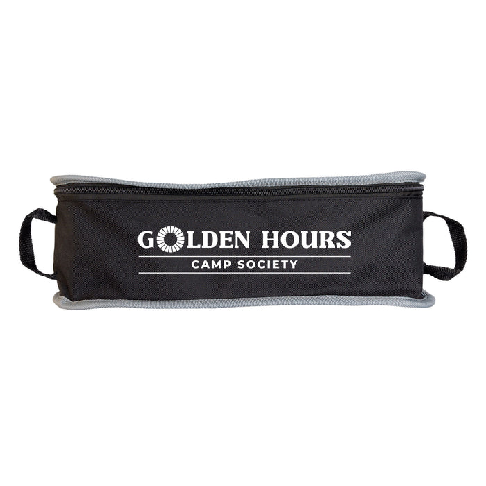 The Escape Pack - A black travel pouch with grey trim and handles, featuring a logo with the words "Golden Hours Camp Society."