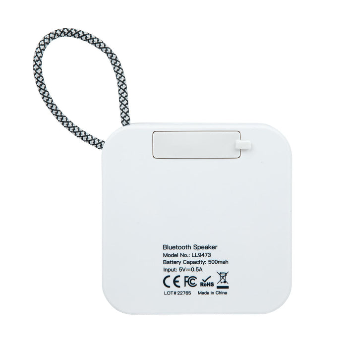 The Escape Pack - A square white Bluetooth speaker with a hanging strap and a small compartment on the back for battery access.