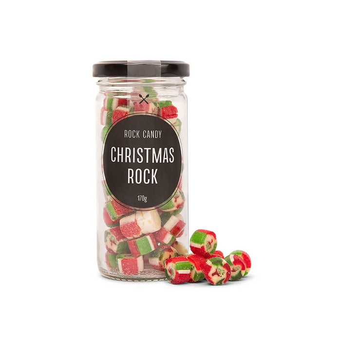 The Perfect Pairing: Christmas Edition - A glass jar filled with red, green, and white rock candy pieces, with some scattered outside. The jar has a black lid.