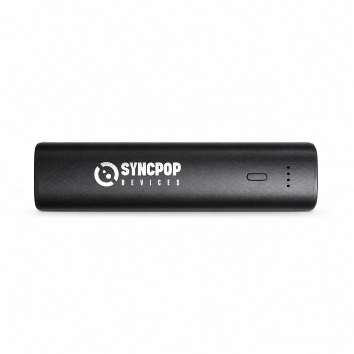 Tech Pack Charge - A black portable charger with a logo and a power indicator light. The design is sleek and rectangular.