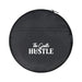 The Hustle Pack - A round black bag with a zip, featuring a logo and the words "The Gentle Hustle" in white.