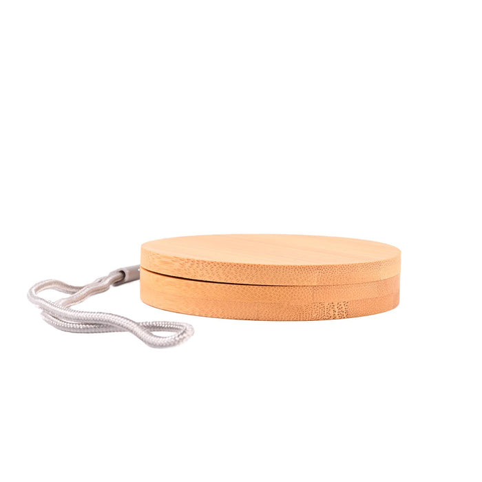The Good Stuff Pack - A circular bamboo product with a grey strap, featuring a smooth, natural finish.