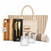 The Weekend Edit - A tote bag with stripes, a wooden cheese board, a two-piece cheese set, two textured glasses, and a striped blanket.