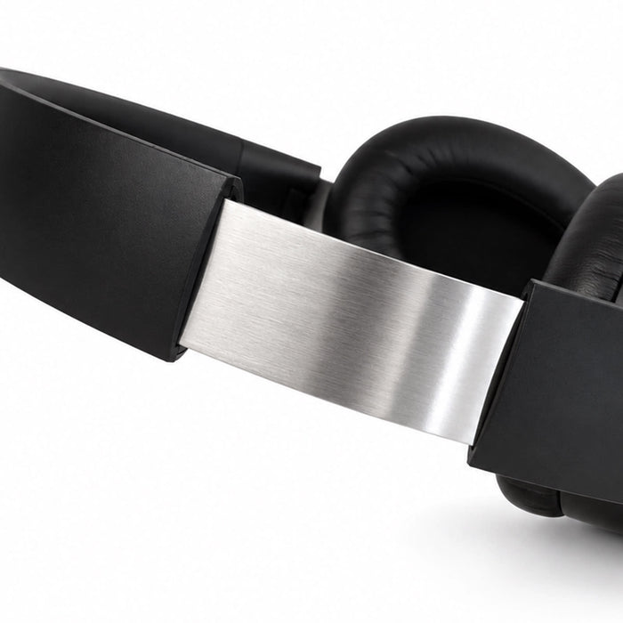 Aero by Nomis Headphones - Aero by Nomis headphones in black with a silver band and cushioned ear pads. Features a sleek design and branding.