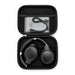 Aero by Nomis Headphones - A pair of black wireless headphones packed in a compact black carrying case, with a charging cable inside.