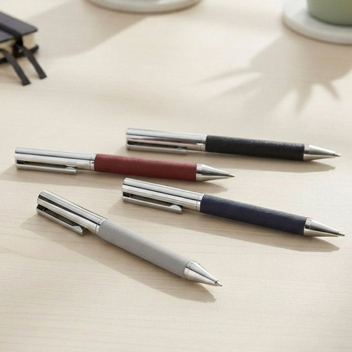 Geneva Metal Pen - A collection of Geneva Metal Pens in grey, maroon, navy, and black with stainless steel accents, arranged on a desk.