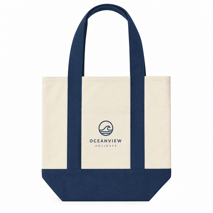 Mini Canvas Tote - A mini canvas tote in cream and navy blue, featuring a logo on the front and sturdy handles.