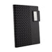 Nexus Notebook - A black notebook with a textured woven design and a silver clip on the side. It features branding on the cover.