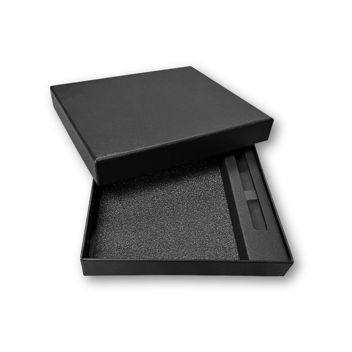 Notebook Gift Set Box - A black gift box containing a notebook and pen, lined with foam for protection.