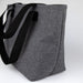 Bavarian Lunch Bag - A grey lunch bag with black straps, featuring a simple design and an external logo.