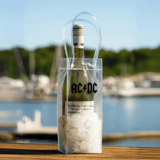 Icy Bags - Medium - A clear cooler bag with a drink bottle, filled with ice, featuring a logo and sturdy handles.
